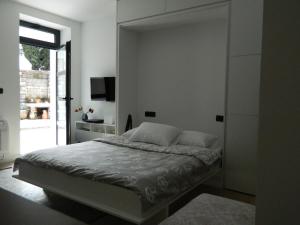 a bedroom with a bed and a television in it at ROSE Downtown in Podgorica