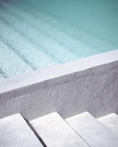 a swimming pool with stairs next to the water at TheLoft32 in Cape Town