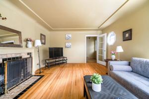 a living room with a couch and a fireplace at Tranquil Haven near Attractions 2BD Upper Floor or 2BD Basement Floor in Vancouver