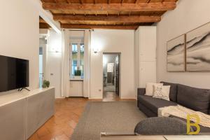 a living room with a couch and a tv at BePlace Apartments in Magenta in Milan