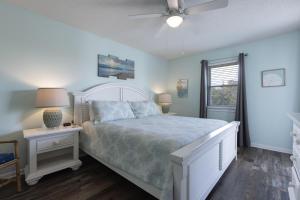 a bedroom with a bed and a ceiling fan at Palmetto 306 in Orange Beach +34 photos