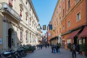 a group of people walking down a street with buildings at Carbonesi Luxury - Centro storico in Bologna