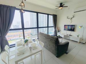 a living room with a couch and a table at Infinity Pool, Georgetown, Up to 11 Pax, 3 Bedrooms, 2 Bathrooms, 2 Car Parks by Star Home in Jelutong
