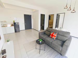 a living room with a couch and a table at Infinity Pool, Georgetown, Up to 11 Pax, 3 Bedrooms, 2 Bathrooms, 2 Car Parks by Star Home in Jelutong