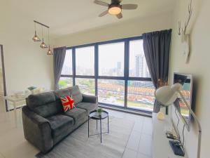 a living room with a couch and a large window at Infinity Pool, Georgetown, Up to 11 Pax, 3 Bedrooms, 2 Bathrooms, 2 Car Parks by Star Home in Jelutong