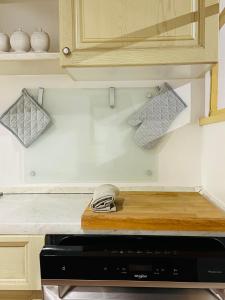a kitchen with a wooden cutting board on a counter at San Pancrazio Home in Treviso +13 photos