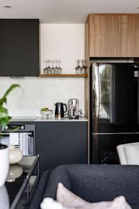 a small kitchen with a stove and a refrigerator at Al Fresco Living apartment in Launceston in Launceston
