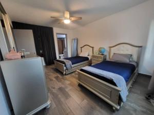 a bedroom with two beds and a ceiling fan at ¡Cómodo departamento con la mejor ubicación! in Tijuana