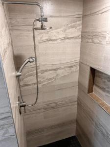 a shower with a shower head in a bathroom at Suite 3 Flèche du fjord vue Saguenay Mont Valin in Saint-Fulgence +22 photos