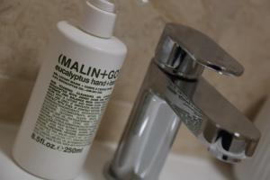 a bottle of toothpaste sitting next to a sink at Yarm Luxury Apartments - Bank House - private gated carpark in Yarm +33 photos