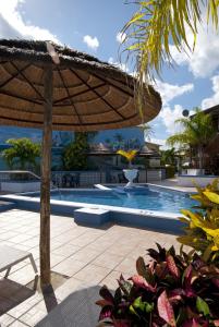 a patio with an umbrella and a swimming pool at Ocean Reef Yacht Club & Resort in Freeport