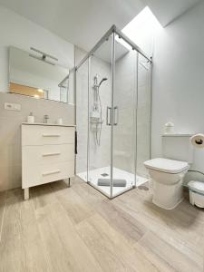 a bathroom with a glass shower and a toilet at Calma & Mar in Arona