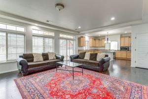 a living room with two couches and a table at Spacious Denver Vacation Home about 18 Mi to Downtown! in Aurora