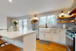 a kitchen with white cabinets and a white counter top at The Hideaway in Harwich