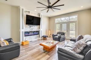 a living room with couches and a flat screen tv at Spacious Hampton Vacation Home Near Beaches! in Hampton
