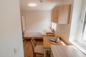 a small room with a table and a bed at Kalkalpen Apartments in Spital am Pyhrn