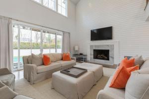 a living room with two couches and a fireplace at Villa Kimaal - Luxury with pool in Sag Harbor