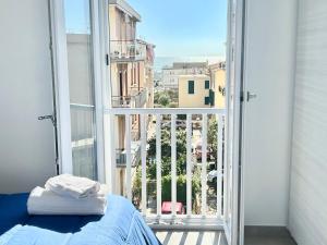 a bedroom with a bed and a large window at Dolce Vita Sperlonga in Sperlonga
