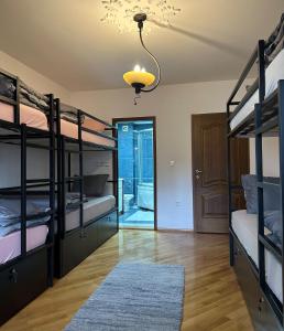 a room with bunk beds and a chandelier at My Mother's House Hostel in Skopje