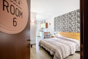 En eller flere senge i et værelse på Alpen Pila Residence Loft 6