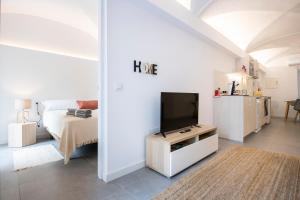 a bedroom with a bed and a tv in a room at Can Planeses in Banyoles