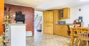 a kitchen with wooden cabinets and a table at Ferienhaus Pfisterhof in Kirchzarten