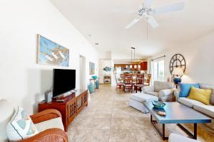 a living room with a couch and a tv at Southern Sun Villa in The Villages