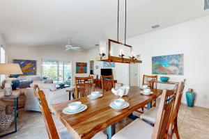 a dining room and living room with a wooden table and chairs at Southern Sun Villa in The Villages