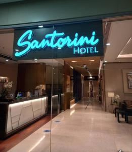 a sign for a santaton hotel in a building at Bel's 2 Bedroom Condo in Santorini Hotel Sta. Lucia Mall Cainta Rizal in Manila