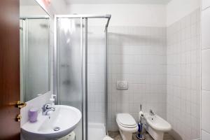 a bathroom with a sink and a toilet and a shower at Alpen Pila Residence Loft 2 in Aosta +23 photos