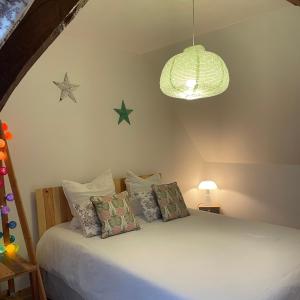 - une chambre dotée d'un lit avec des étoiles sur le mur dans l'établissement Ecolodge ENTRE MER & CAMPAGNE - Maison d'Hôtes POMME DE PAILLE - Entre Honfleur et Etretat, à Octeville-sur-Mer
