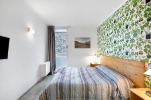 a small bedroom with a bed and a window at Alpen Pila Residence Loft 5 in Aosta