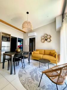 a living room with a yellow couch and a table at Domaine le Vaxergues in Saint-Affrique