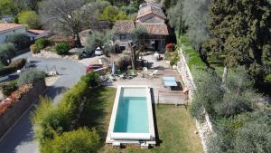 an aerial view of a house with a swimming pool at Mas Osmeea in Roquefort-les-Pins