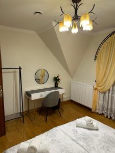 a bedroom with a desk and a bed at Villa Sophie in Żabno