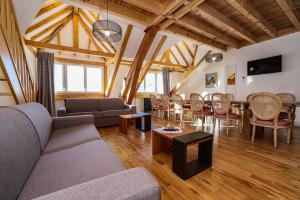 a living room with a couch and a table at RESIDENCE LE SPLENDID in Villard-de-Lans