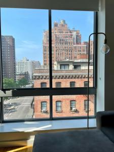 a view of a building from a large window at 2 bedrooms Chelsea apartment - Manhattan in New York