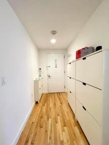 a room with white cabinets and a hard wood floor at 2 bedrooms Chelsea apartment - Manhattan in New York