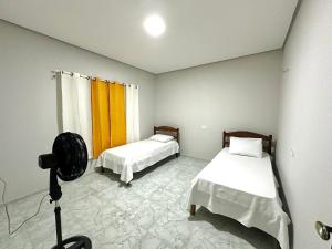 a room with two beds and a camera in it at Apartamento em Pedro II in Pedro II