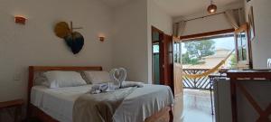 a bedroom with a bed with a butterfly on the wall at Pousada Real Cipo in Serra do Cipo +66 photos