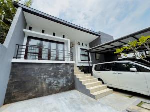 a white van parked in front of a house at ADORA Home Bandung chill & cozy in Bandung