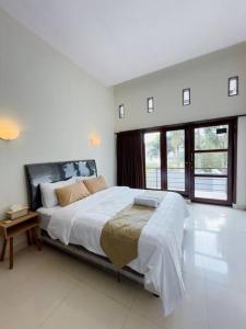 a large white bedroom with a large bed in it at ADORA Home Bandung chill & cozy in Bandung