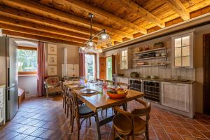a large kitchen with a long wooden table and chairs at Villa Carlotte - quiet and comfort in Pastrengo