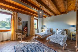 a bedroom with two beds and a chair and a window at Villa Carlotte - quiet and comfort in Pastrengo