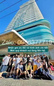 a group of people posing in front of a building at TMS Quy Nhơn View Biển in Quy Nhon