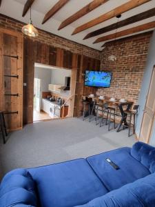 a living room with a blue couch and a dining room at New with Free Offstreet Parking The Old Drill Hall 3 in Ryde