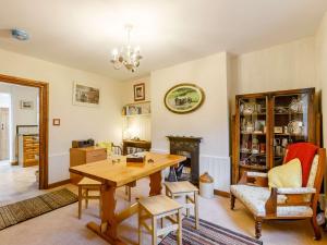 a living room with a wooden table and a fireplace at 3 Bed in Shipston-on-Stour 90481 in Honington