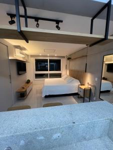 a bedroom with a large bed and a large window at Apartamento/Studio Novo Hamburgo in Novo Hamburgo