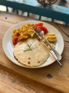 a plate of food with a tortilla and vegetables on a table at Parcerito's Hostel in Jericó