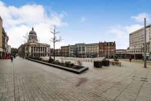 a city street with buildings and a building with a dome at Spacious 1 Bed Apartment 1 Minute Walk from Square in Nottingham